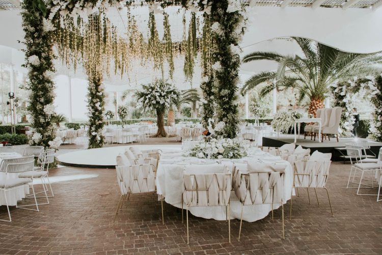 Stunning outdoor wedding setup featuring floral decorations, elegant seating, and ambient lighting. — Creative Approaches to