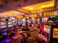 An interior view of a casino showcasing various slot machines under bright lights.