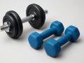 two sets of dumbbells on a plain background
